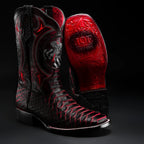 Black and red cowboy boots with intricate designs on a black background
