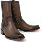 Pair of brown leather boots with a zipper on a white background