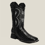 Black cowboy boot with intricate white embroidery on a light gray background