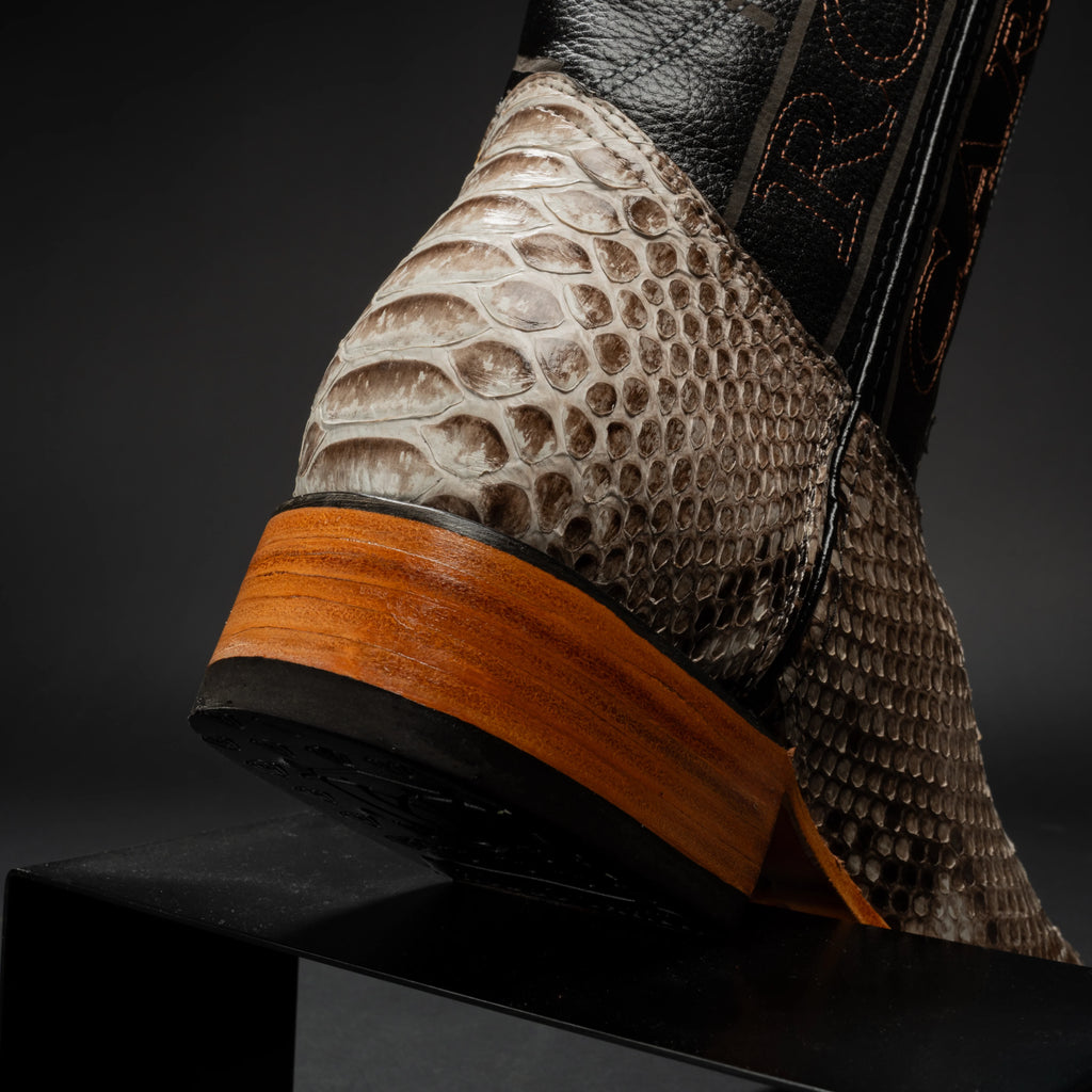 Close-up of a shoe with a textured sole and heel on a dark background