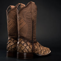 Pair of brown cowboy boots with patterned soles on a black background