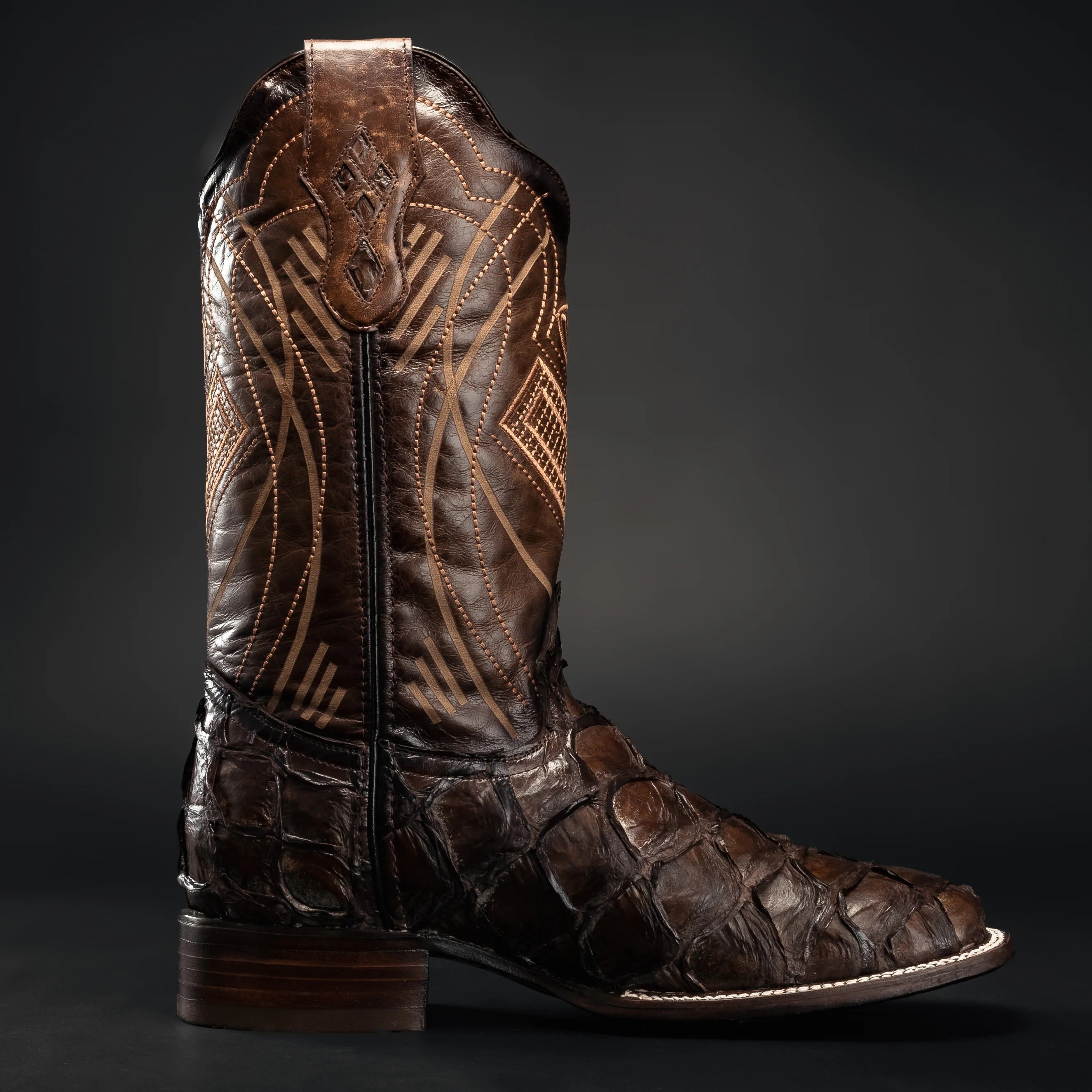 Close-up of genuine pirarucu leather texture on brown cowboy boots