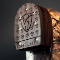 Close-up of a brown leather boot heel with 'Rodeo Carter' branding on a dark background