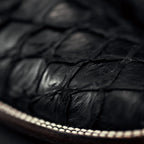 Close-up of black leather cow boy boots with a blurred background