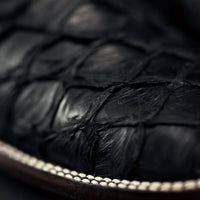Close-up of black leather cow boy boots with a blurred background