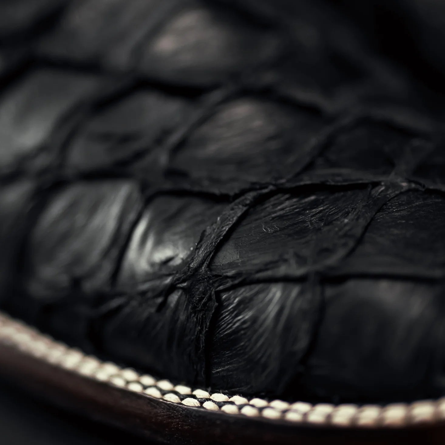 Close-up of black leather cow boy boots with a blurred background