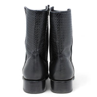 Pair of black leather boots on a white background