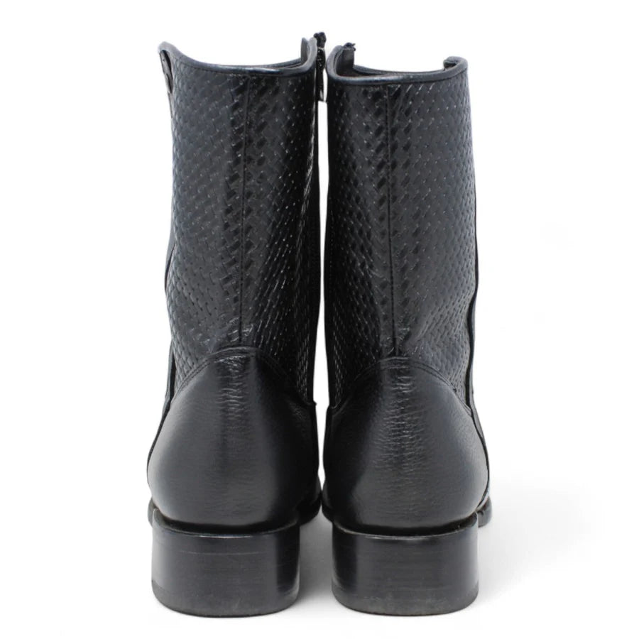 Pair of black leather boots on a white background