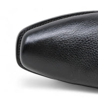 Close-up of a black leather shoe sole on a white background